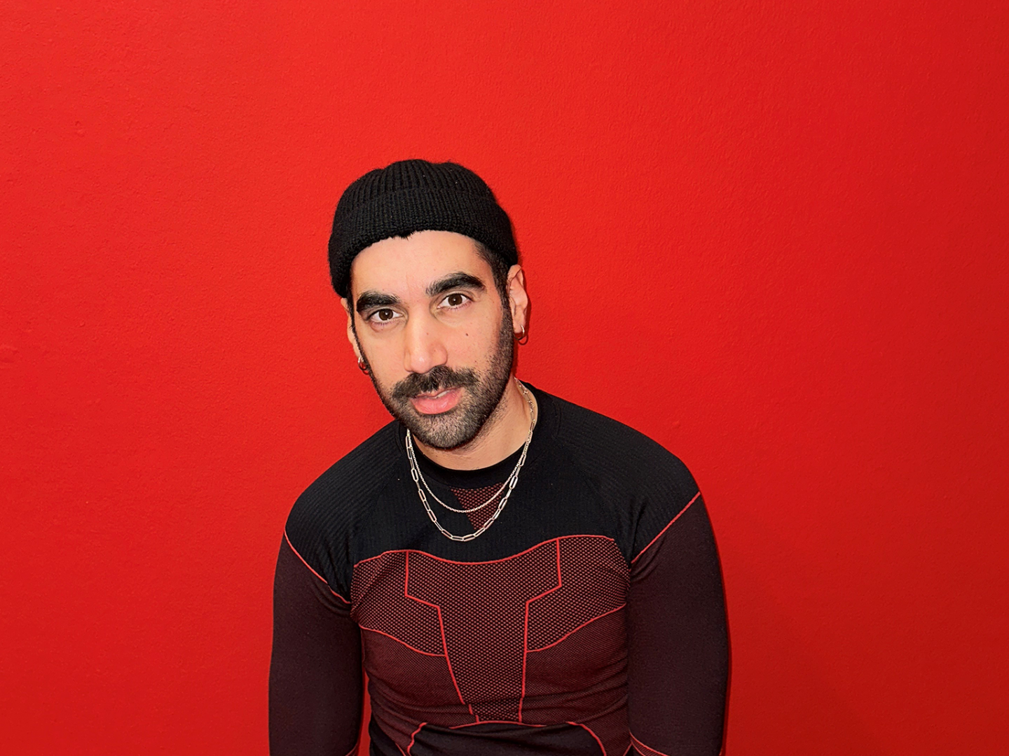 Murat Dikenci vor rotem Hintergrund
