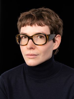 Das Bild zeigt Svea Klein mit einer gelben Briller vor einem schwarzen Hintergrund