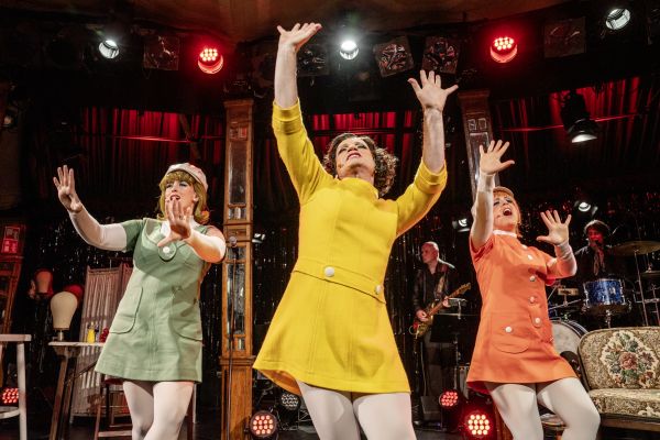 Foto von einer Aufführung der Geschwister Pfister, alle drei tragen Kleider im 60er Jahre-Stil