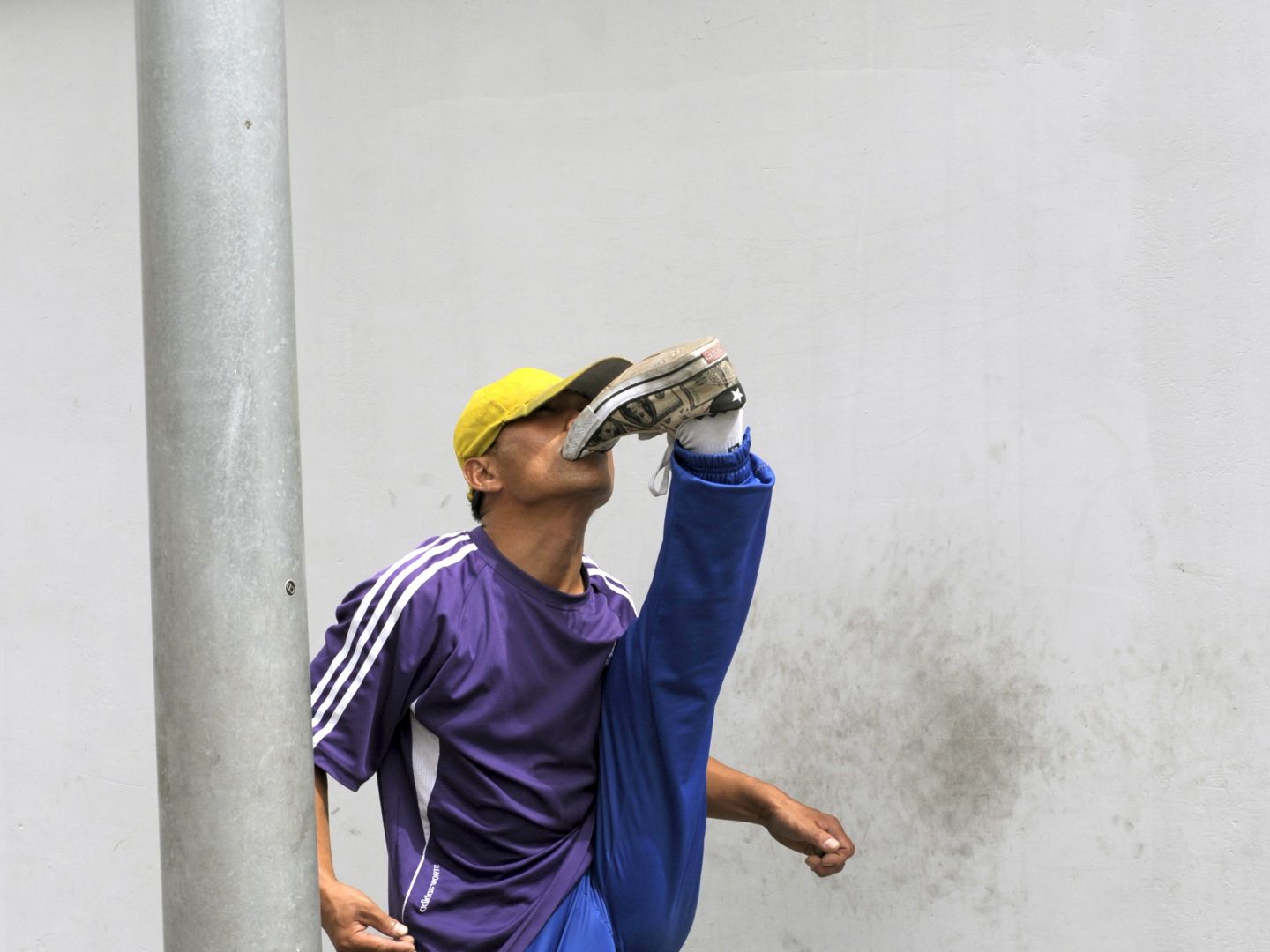 Ein Mann im Trainingsanzug, der sich in den Schuh beist