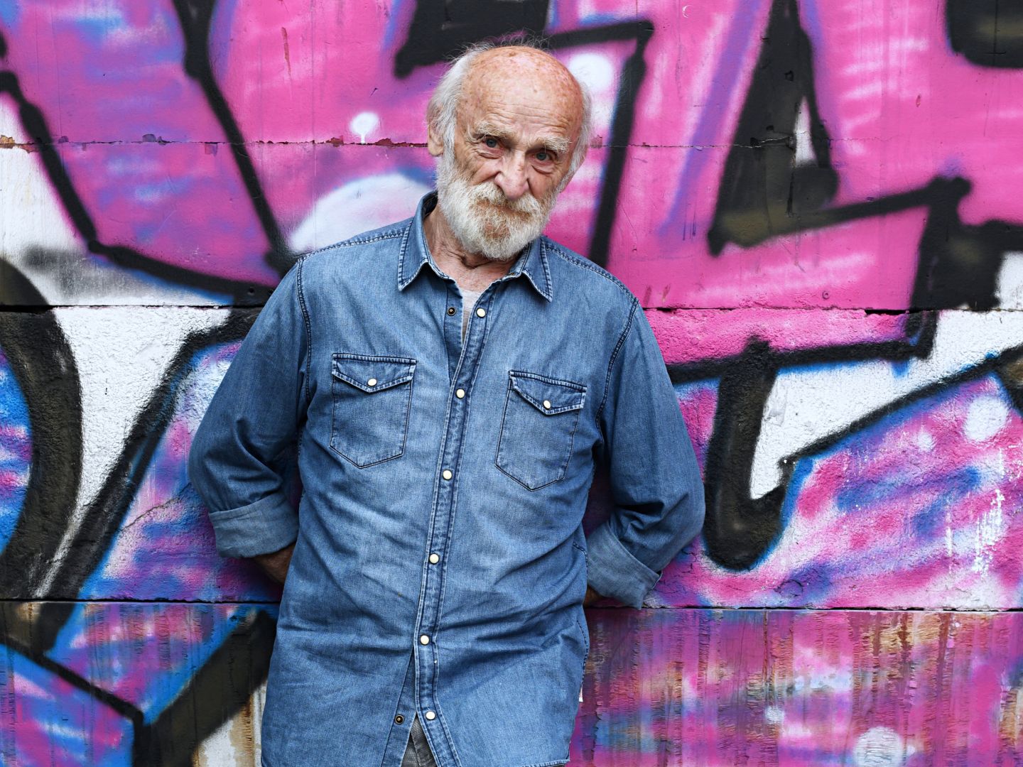 Portrait von Peter Mitterrutzner vor einer Graffiti-Wand